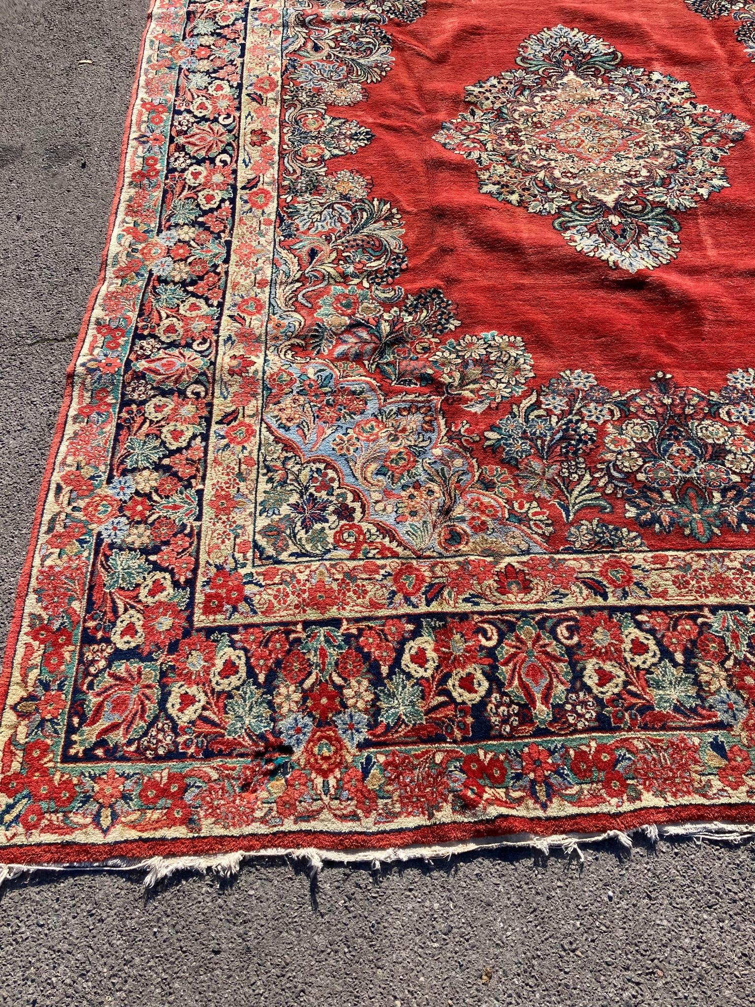 A large North West Persian red ground carpet, 361cm x 274cm